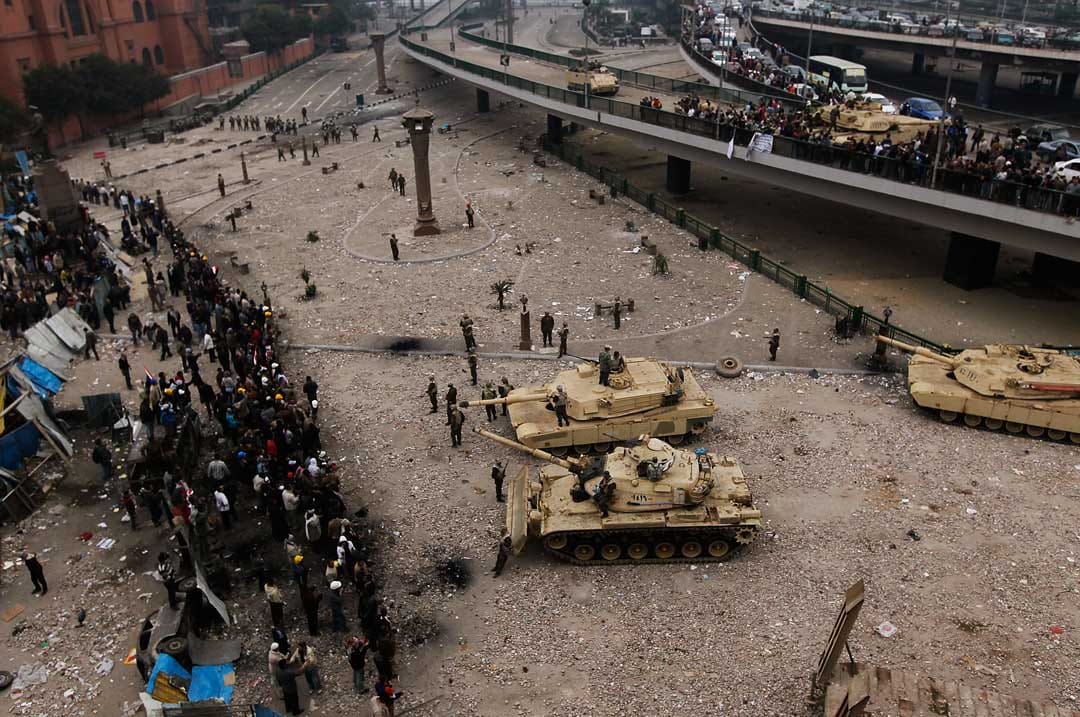  2011年2月5日，埃及开罗，埃及军队以坦克和刀片刺网分隔在解放广场的反政府示威者及穆巴拉克支持者。摄：Chris Hondros/Getty