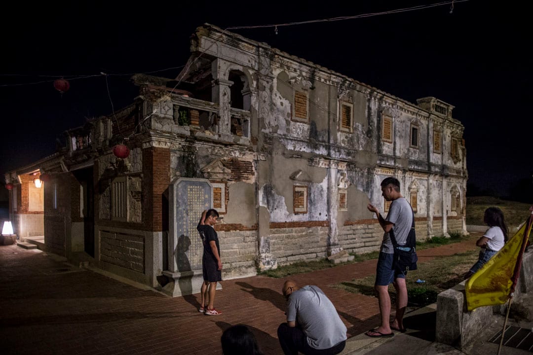 金门古洋楼曾为共军指挥所，墙上布满战争痕迹，旁边现在是一间民宿，与古洋楼相连。