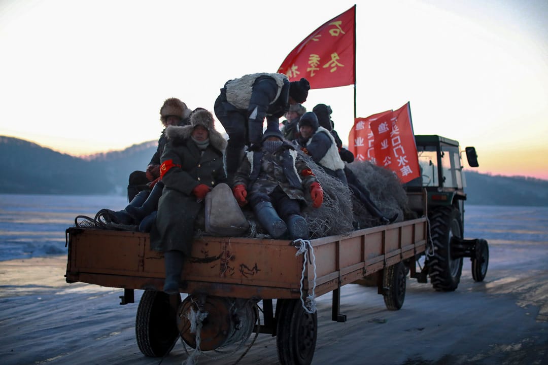 摄氏零下24摄氏,渔民穿上厚厚的大衣,乘坐拖拉机在冰上行走。