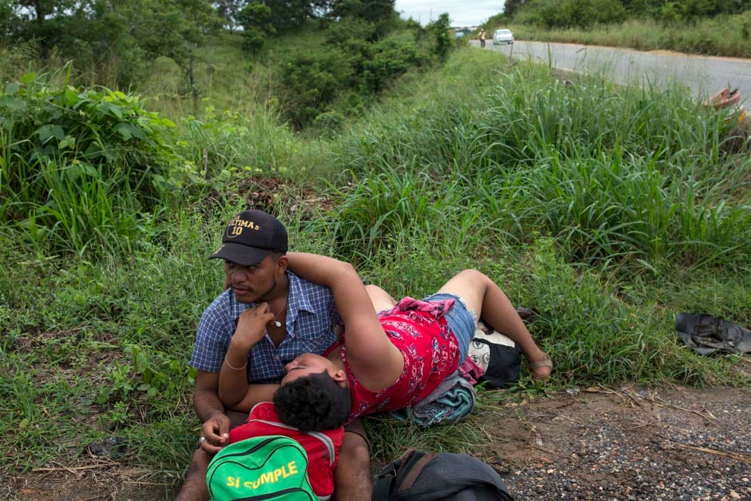 一對同性戀情侶在路邊等待前往薩尤拉的順風車。
