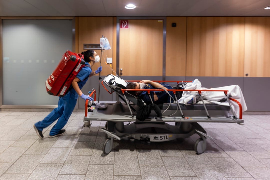 2022年1月1日，奧地利城市茵斯布魯克，一名在元旦日當值的護士將一名有抽搐症狀的病人推到掃瞄器進行電腦斷層掃描。