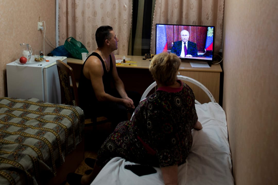 2022年2月21日,乌克兰东部的顿涅茨克和卢甘斯克地区,人们在临时住所观看俄罗斯总统普京的讲话。