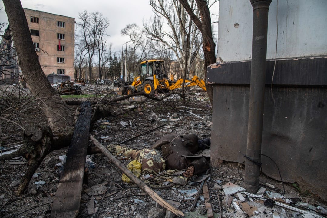 2022年4月18日，乌克兰城市马里乌波尔，邻近亚速钢铁厂的民居被俄军炮轰，一名遇难居民的遗体躺在地上。